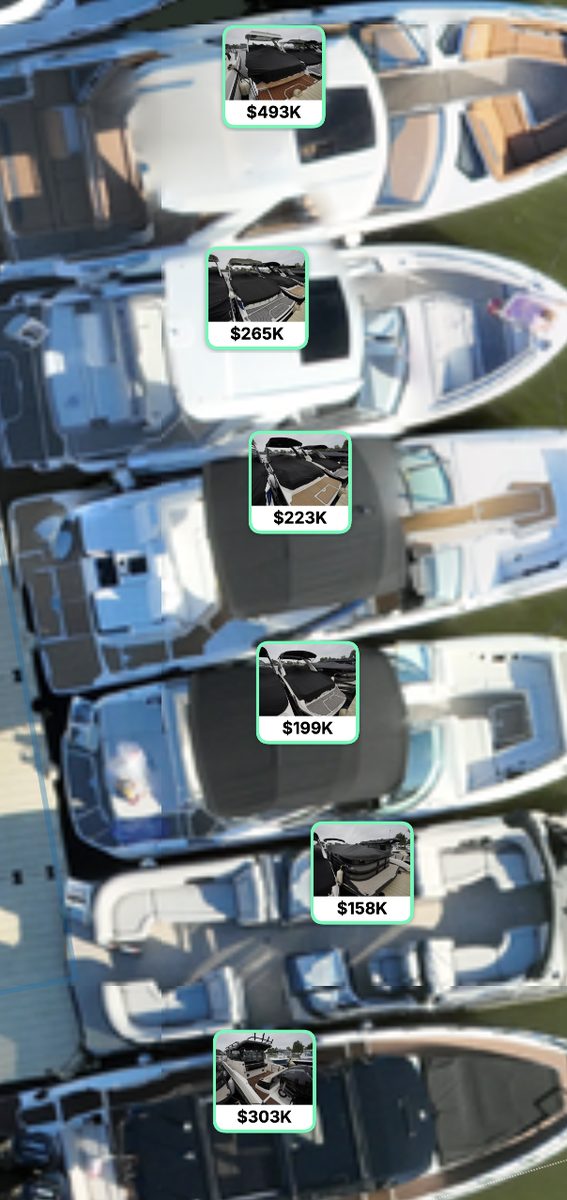 Close up of boats at a dock, each tagged with a photo and price